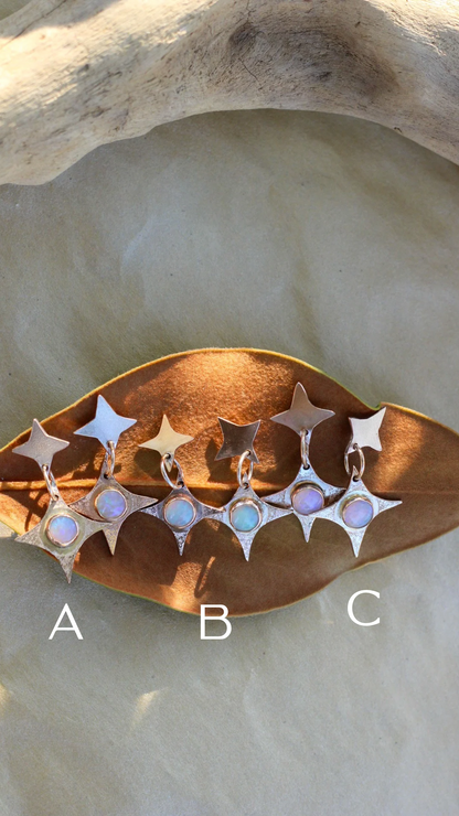 Star-shaped earrings on a stone surface with labels A, B, and C.