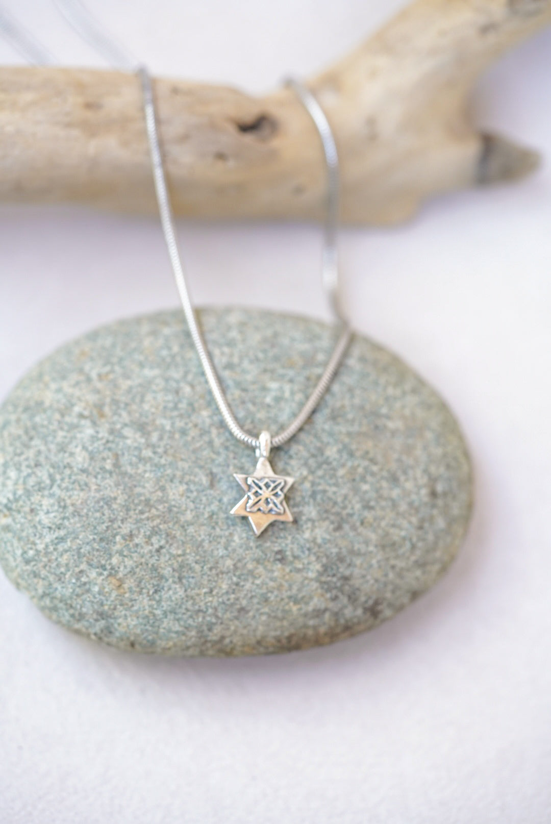 Necklace with a star pendant on a stone surface