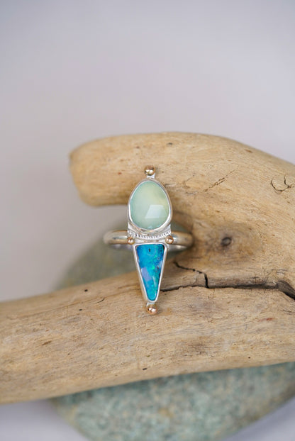 Silver ring with opal and chalcedony on a piece of driftwood