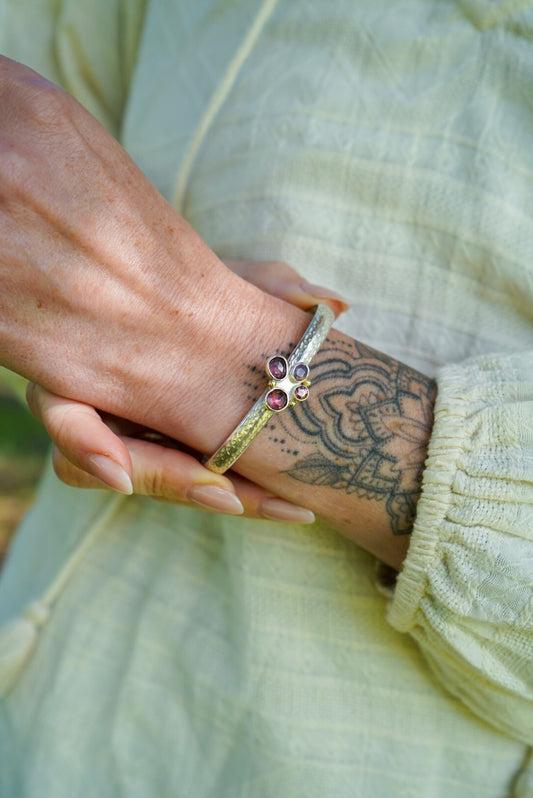 Close-up of a hand wearing a bracelet with a white background